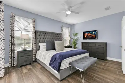 a bedroom with a bed and a ceiling fan at 8131 Sun Palm in Kissimmee