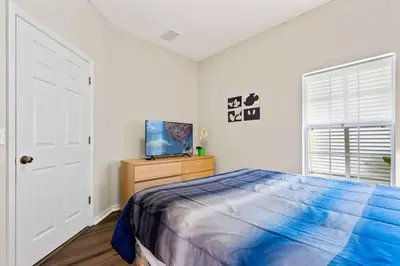 a bedroom with a bed and a tv on a dresser at 4 Bedroom 3 Bathroom Terra Verde 111PB in Kissimmee