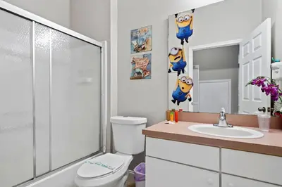 a bathroom with a shower and a toilet and a sink at 4 Bedroom 3 Bathroom Terra Verde 111PB in Kissimmee