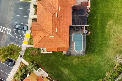 an overhead view of a house with an orange roof at 4 Bedroom 3 Bathroom Terra Verde 111PB in Kissimmee