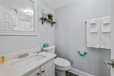 a white bathroom with a toilet and a sink at Exclusive Ground floor Apartment with Balcony in Orlando