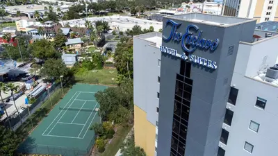 an aerial view of a tennis court in front of a building at Exclusive Ground floor Apartment with Balcony in Orlando