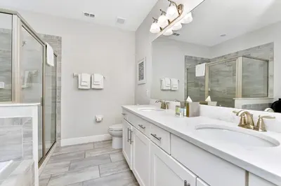 a white bathroom with two sinks and a toilet at Lavish Home Near Disney With Media, Game & Theme Rooms With Waterpark & Resort Access At Encore Resorts Reunion - 520Bu in Kissimmee