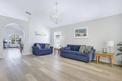 a living room with two blue couches and a table at 7832 Cozy Gem at Indian Ridge with Pool in Orlando