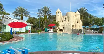 a resort pool with a castle in the background at Disney's Key West Resort Studio room sleeps 4 in Orlando