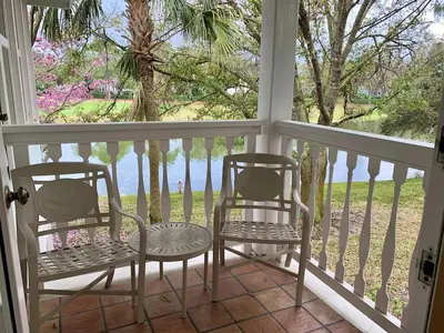 two chairs and a table on a porch at Disney's Key West Resort Studio room sleeps 4 in Orlando