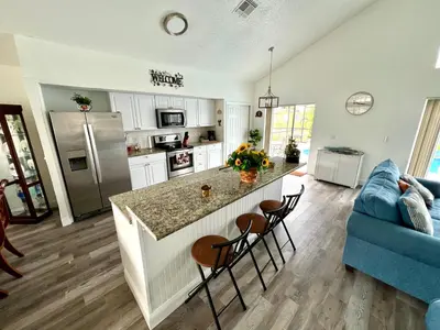 a kitchen and living room with a blue couch at Buena Ventura Escape in Kissimmee