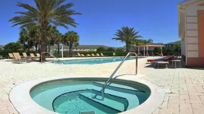 a swimming pool with a hot tub in a resort at Shvck4 - Coral Cay Resort #4 - 4 Bed 3 Baths Townhome in Kissimmee