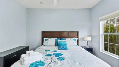a bedroom with a large bed with blue and white at Shvck4 - Coral Cay Resort #4 - 4 Bed 3 Baths Townhome in Kissimmee