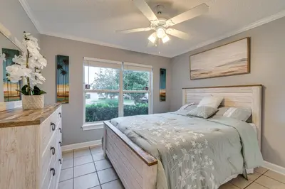 a bedroom with a bed and a window at Lovely Florida Retreat with Lanai 5 Mi to Riverwalk in Lake Mary