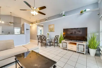 a living room with a large flat screen tv at Lovely Florida Retreat with Lanai 5 Mi to Riverwalk in Lake Mary