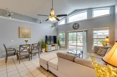 a living room with a couch and a table at Lovely Florida Retreat with Lanai 5 Mi to Riverwalk in Lake Mary