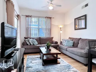 a living room with a couch and a tv at Lovely Family Town home in Great Location townhouse in Kissimmee