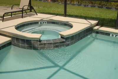 a small swimming pool with a bench in a yard at Beautiful Renovated 6 Bed Pool Home home in Kissimmee