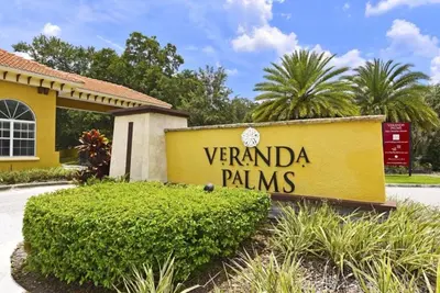 a sign in front of a yellow building at Beautiful Renovated 6 Bed Pool Home home in Kissimmee