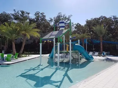 a water park with a slide in a swimming pool at Beautiful Renovated 6 Bed Pool Home home in Kissimmee