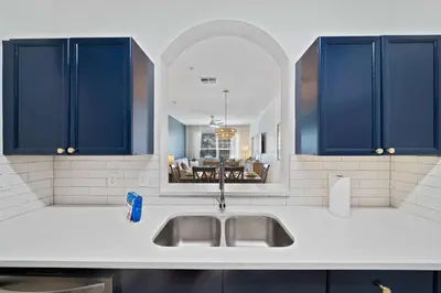 a kitchen with a sink and a dining room at 2301 Butterfly Palm Way 101 in Kissimmee