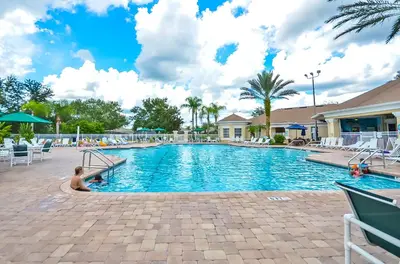 a swimming pool with a child sitting in the middle at 2301 Butterfly Palm Way 101 in Kissimmee