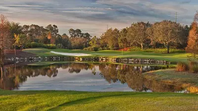 a view of a golf course with a pond at Near Disney - 3BR Condo - Games Pool & Sauna in Orlando