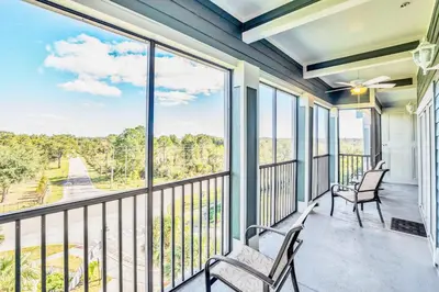 a balcony with two chairs and a large window at Pet-Friendly 3BR Condo w Pool in Orlando