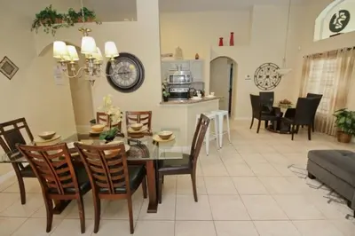 a dining room and living room with a table and chairs at Gorgeous 4 Bed Home In Gated Community! villa in Kissimmee