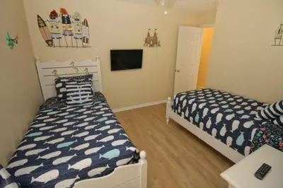 a bedroom with two beds and a tv at Gorgeous 4 Bed Home In Gated Community! villa in Kissimmee