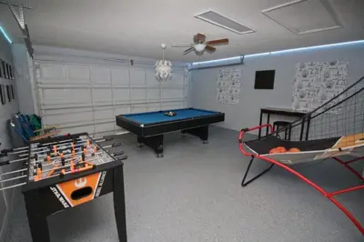 a room with a ping pong table and a pool table at Gorgeous 4 Bed Home In Gated Community! villa in Kissimmee