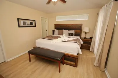 a bedroom with a large bed and a table at Gorgeous 4 Bed Home In Gated Community! villa in Kissimmee
