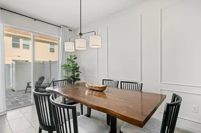a dining room with a wooden table and chairs at Charming Challet at Compass Bay CB101 in Kissimmee