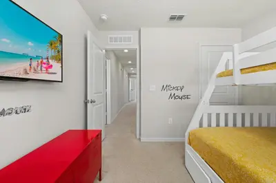 a bedroom with a bunk bed and a red bench at Charming Challet at Compass Bay CB101 in Kissimmee