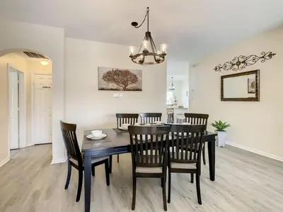 a dining room and kitchen with a table and chairs at 2025 Deals Are Here! Book Now Before Rates Go Up! in Kissimmee