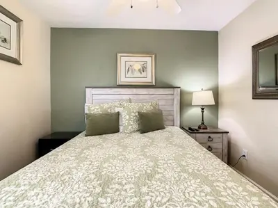 a bedroom with a bed with a white bedspread at 2025 Deals Are Here! Book Now Before Rates Go Up! in Kissimmee