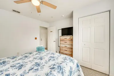a bedroom with a bed and a ceiling fan at 11 Mi to Disney Venetian Bay Villages Townhome! in Kissimmee
