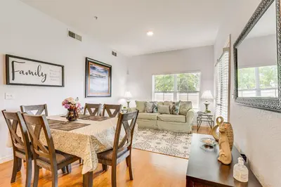 a dining room and living room with a table and chairs at 11 Mi to Disney Venetian Bay Villages Townhome! in Kissimmee