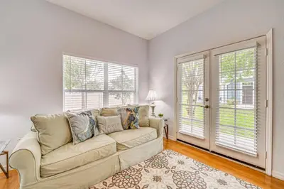 a living room with a couch and two windows at 11 Mi to Disney Venetian Bay Villages Townhome! in Kissimmee