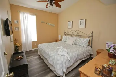 a bedroom with a bed and a ceiling fan at Luxury Villa With Private Pool And Great Game Room villa in Kissimmee