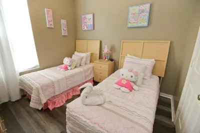 two beds with stuffed animals on them in a bedroom at Luxury Villa With Private Pool And Great Game Room villa in Kissimmee