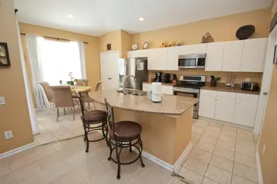 a kitchen with a large island in the middle at Luxury Villa With Private Pool And Great Game Room villa in Kissimmee