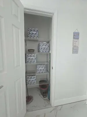 a door open to a closet filled with blue and white boxes at Happy Place in Orlando