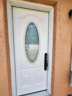 a white door with a round window on it at Happy Place in Orlando