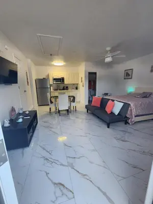 a large living room with a couch and a table at Happy Place in Orlando