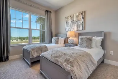 two beds in a bedroom with a window at 5 BR 6 BA Villa 5min to Disney! SMV154 in Orlando