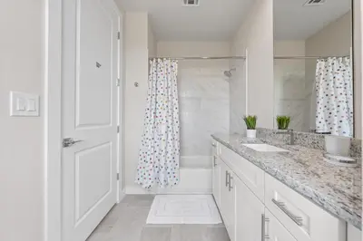 a white bathroom with a shower and a sink at Comfortable home w 3 En-suites! SMV157 in Orlando