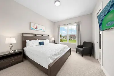 a bedroom with a bed and a chair and a window at 4 Bedrooms 3 En-Suites, 5 Min to Disney SMV158 in Orlando