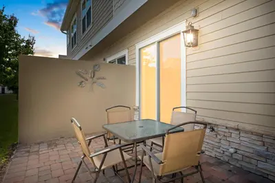 a table and chairs sitting on a patio at 4 Bedrooms 3 En-Suites, 5 Min to Disney SMV158 in Orlando