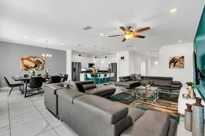a living room with a couch and a ceiling fan at Luxury Home at Sonoma 9 En-suites SON102 in Kissimmee