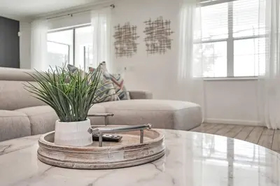 a living room with a table with a plant on it at Luxury Villa w Pool, Home Cinema, BBQ & Near Disney Parks in Kissimmee