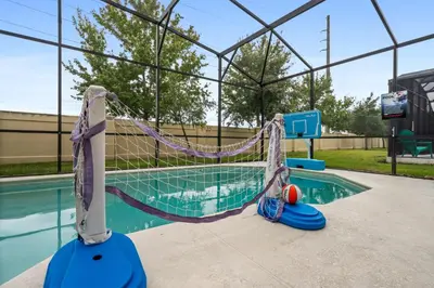 a swimming pool with a hammock in a batting cage at Luxury Villa w Pool, Home Cinema, BBQ & Near Disney Parks in Kissimmee