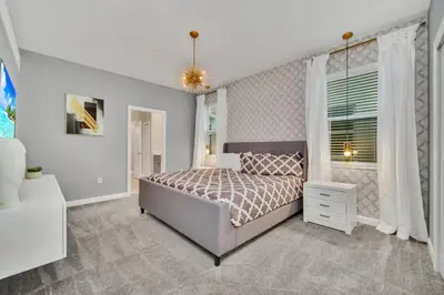 a bedroom with a bed and a window at 9 BR Family Home 8 Minutes to Disney STL119 in Kissimmee