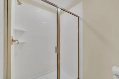 a shower with a glass door in a bathroom at 9 BR Family Home 8 Minutes to Disney STL119 in Kissimmee